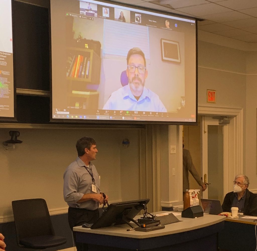 Robert Hufnagel is shown on the screen.  Jim Lauderdale is standing underneath the screeen talking.  